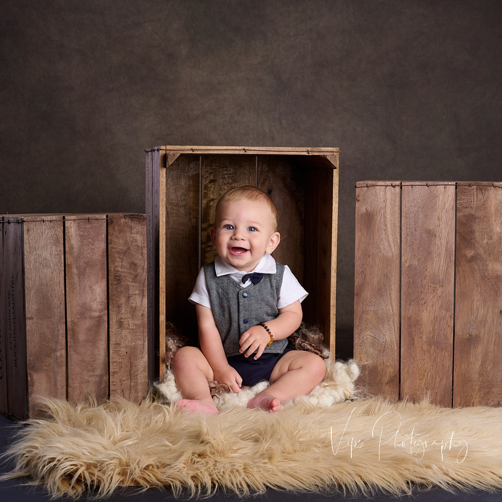 photo of one year old child in brown boxes